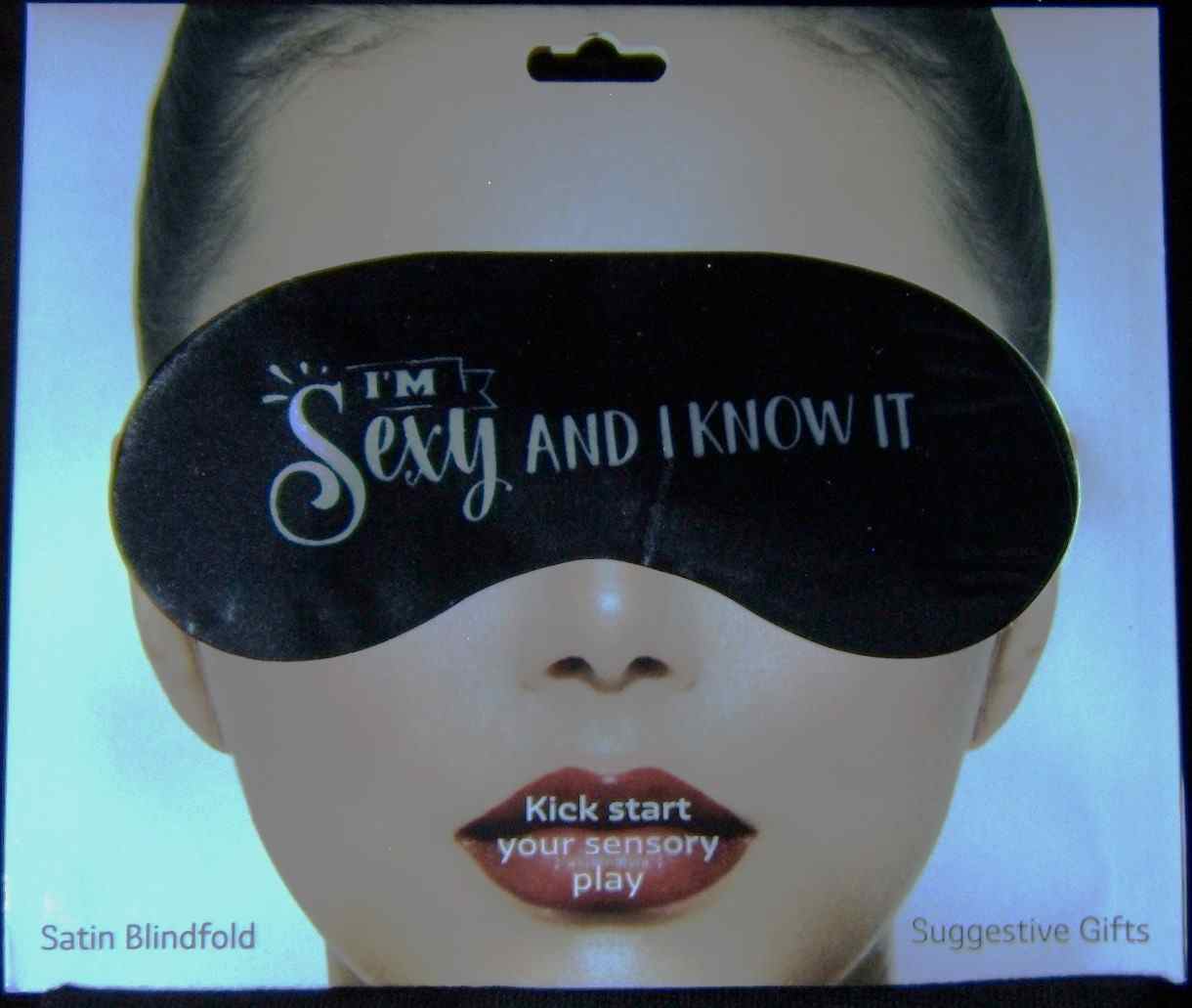 A woman with a black eye mask on her face.