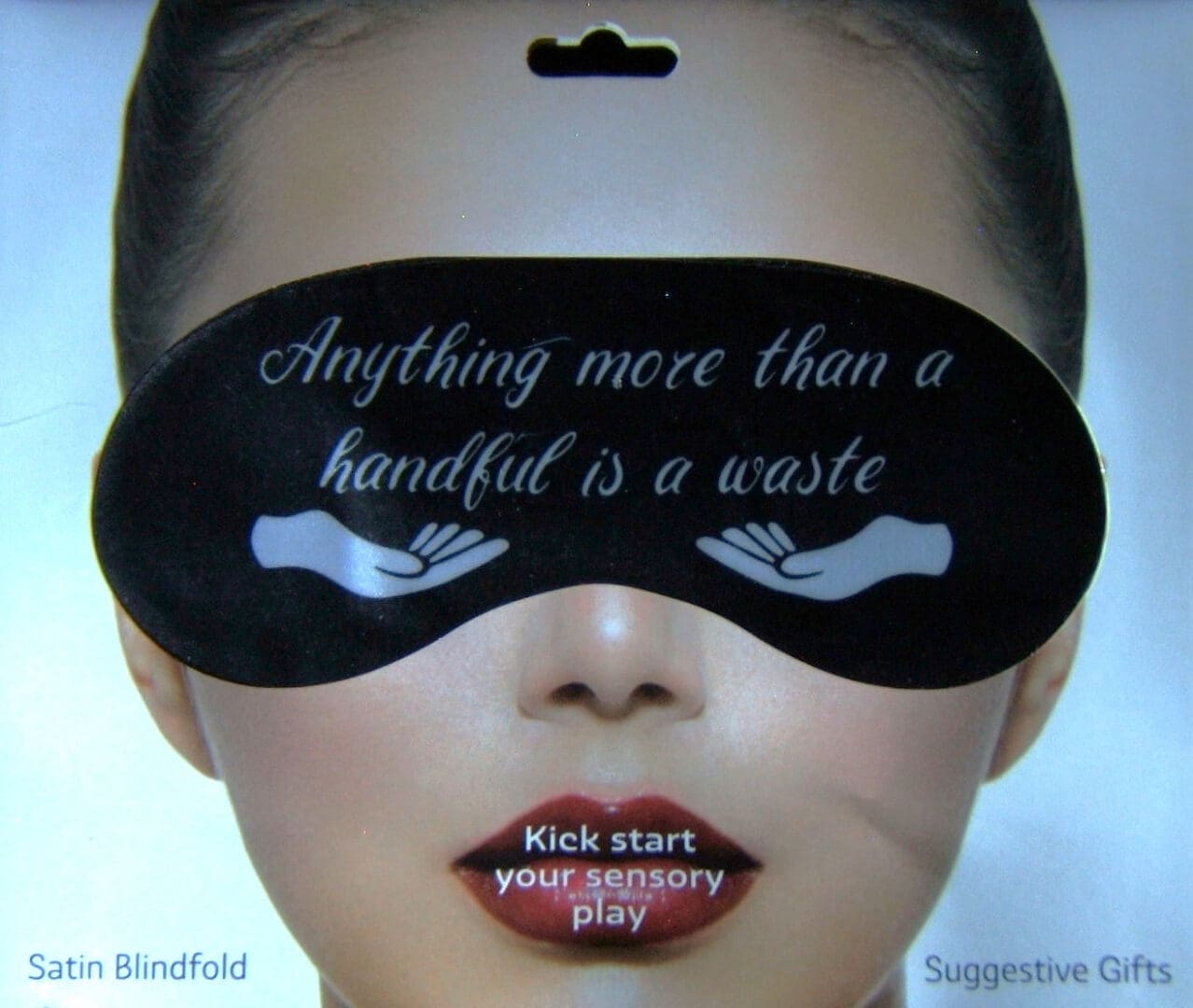 A woman with a black eye mask on her face.