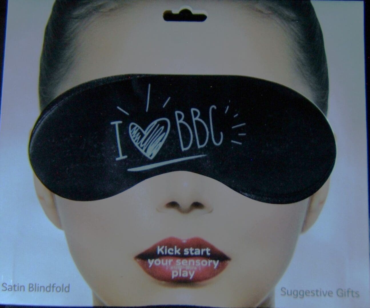 A woman wearing a blindfold with the words " i love bbc " written on it.