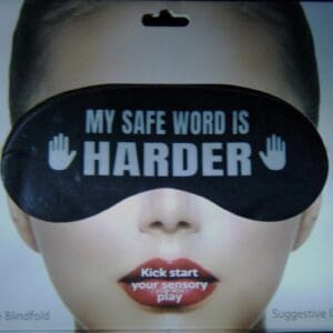 A woman wearing a black eye mask with the words " my safe word is harder ".