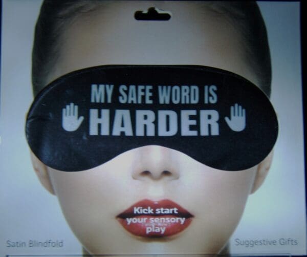 A woman wearing a black eye mask with the words " my safe word is harder ".