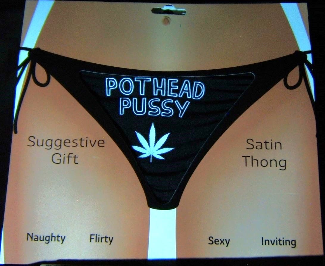 A black and white picture of some panties with the words pothead pussy written on them.