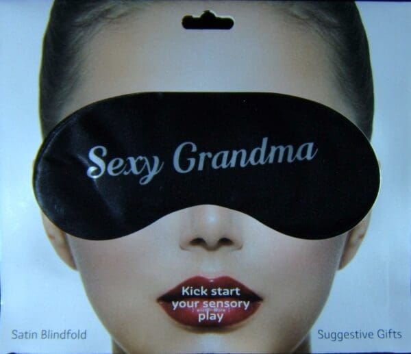 A woman wearing a black eye mask with the words " sexy grandma ".