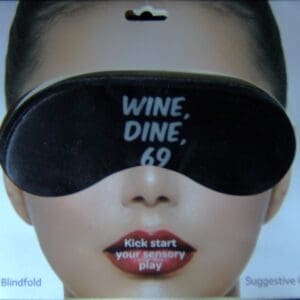 A woman wearing a blindfold and a wine glass.