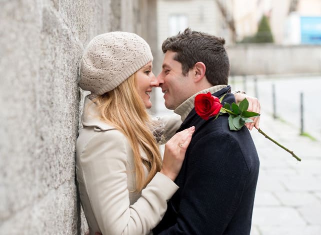 A man and woman are kissing each other.